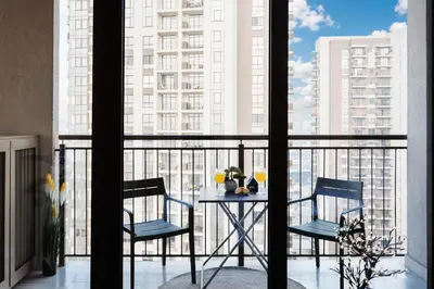 a table and two chairs on a balcony with a view at WF Sky Charm with Terraces & Billiard in Belgrade