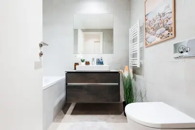 a white bathroom with a sink and a toilet at WF Sky Charm with Terraces & Billiard in Belgrade