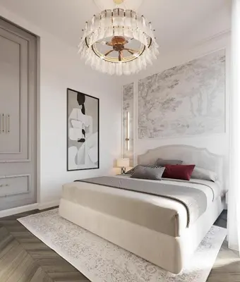 a white bedroom with a large bed and a chandelier at White Gallo Residences in Belgrade