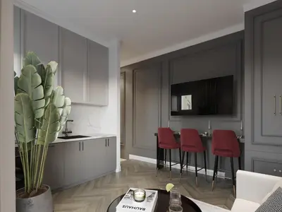 a kitchen with red chairs and a table at White Gallo Residences in Belgrade