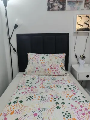 a bed with a black headboard and a colorful bedspread at Kalemegdan 2 in Belgrade
