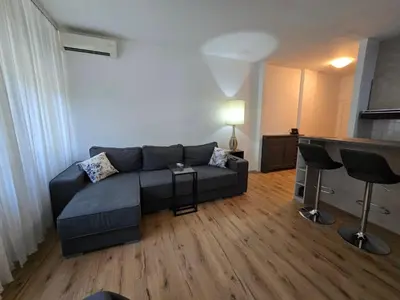a living room with a blue couch and a table at The Chill Zone Kralja Petra in Belgrade