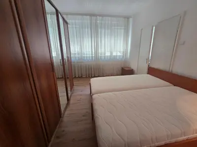 a small bedroom with a bed and a mirror at The Chill Zone Kralja Petra in Belgrade