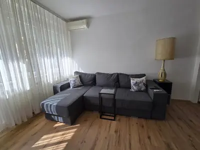 a living room with a gray couch and a lamp at The Chill Zone Kralja Petra in Belgrade