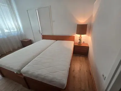 a bed in a bedroom with a lamp on a table at The Chill Zone Kralja Petra in Belgrade