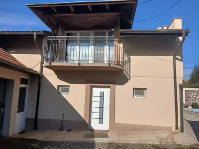 a house with a balcony and a door at Villa Atlantis in Guncati