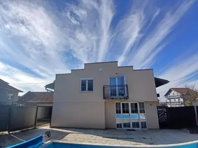 a white house with a balcony on top of it at Villa Atlantis in Guncati