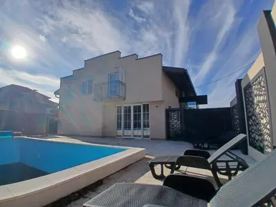 a villa with a swimming pool and a house at Villa Atlantis in Guncati