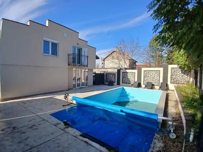 a swimming pool in front of a house at Villa Atlantis in Guncati