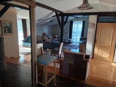 a kitchen and living room with a table and chairs at Villa Atlantis in Guncati