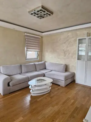 a living room with a couch and a table at Kolet Zemun in Belgrade