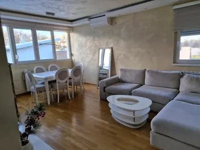 a living room with a couch and a table at Kolet Zemun in Belgrade