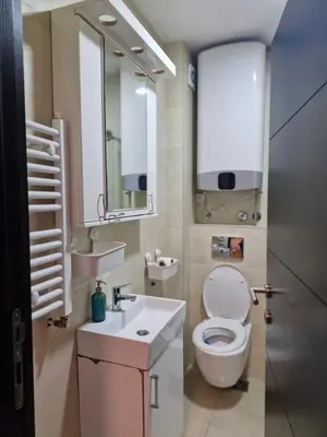 a bathroom with a toilet and a sink and a mirror at Kolet Zemun in Belgrade