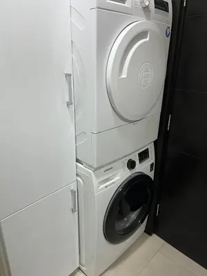 a white washer and dryer next to a refrigerator at Kolet Zemun in Belgrade