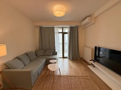 a living room with a couch and a tv at BW Maca - Aurora in Belgrade