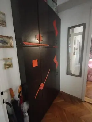 a black cabinet in a room with red notes on it at Apartment Kalis in Belgrade