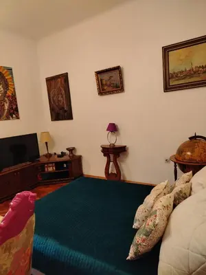 a living room with a bed and a flat screen tv at Apartment Kalis in Belgrade