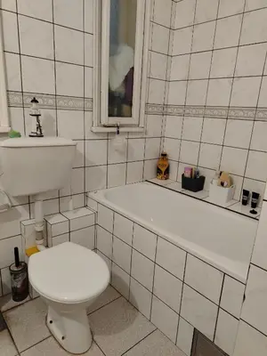 a bathroom with a toilet and a tub and a sink at Apartment Kalis in Belgrade