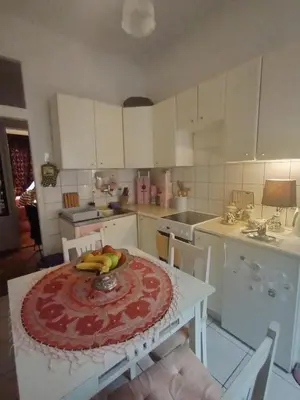 a kitchen with a table with a cake on it at Apartment Kalis in Belgrade