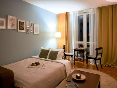 a hotel room with a bed and a table at Ollio Elegant Vintage in Belgrade