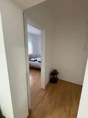 an empty room with a bed in a bedroom at Apartman Tijana in Ruma