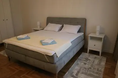 a bedroom with a bed with two towels on it at Suncana Oaza in Belgrade