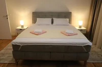 a bedroom with a large bed with two towels on it at Suncana Oaza in Belgrade