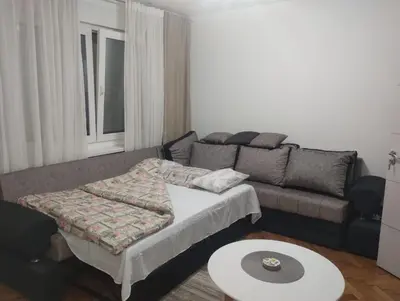 a living room with a couch and a table at Cozy one in Belgrade centre in Belgrade