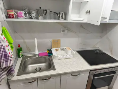 a small kitchen with a sink and a stove at Cozy one in Belgrade centre in Belgrade
