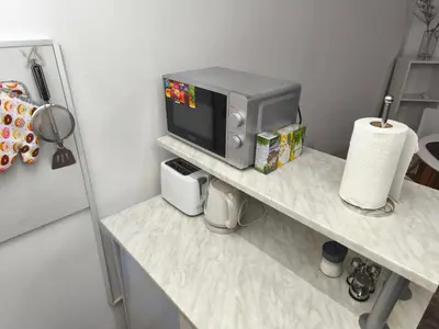 a counter with a microwave on top of a table at Cozy one in Belgrade centre in Belgrade