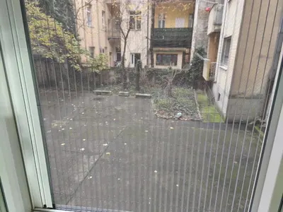 a sliding glass door with a view of a courtyard at Cozy one in Belgrade centre in Belgrade