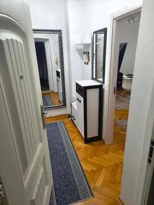a hallway with a bathroom with a mirror and a sink at Cozy one in Belgrade centre in Belgrade