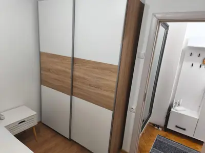 a room with a glass closet with a mirror at Cozy one in Belgrade centre in Belgrade