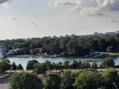 a view of a lake with trees and a city at Pogled Ada 1 in Belgrade