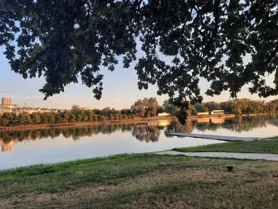 a view of a river with trees and a bridge at Pogled Ada 1 in Belgrade
