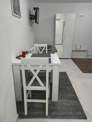 a kitchen with a white table in a room at Apartmani B&R in Lazarevac