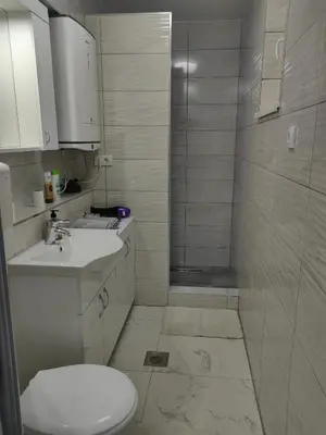 a bathroom with a shower and a toilet and a sink at Apartmani B&R in Lazarevac