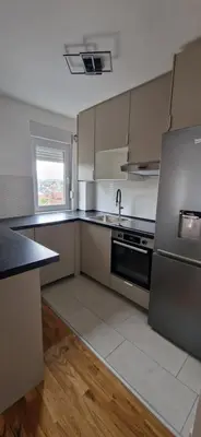 a kitchen with stainless steel appliances and a sink at ETA Apartments in Belgrade