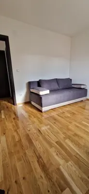 a couch in a room with a wooden floor at ETA Apartments in Belgrade