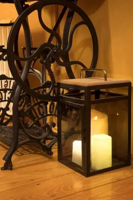 a candle in a glass box next to a chair at Morning Star River Retreat - A Boathouse in Belgrade in Belgrade