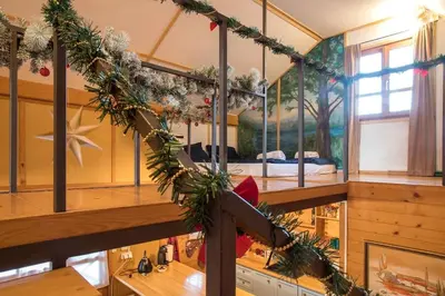 a room with a bed with christmas decorations at Morning Star River Retreat - A Boathouse in Belgrade in Belgrade