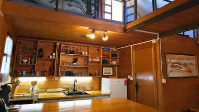 a kitchen with wooden cabinets and a white refrigerator at Morning Star River Retreat - A Boathouse in Belgrade in Belgrade