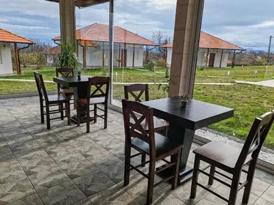 two tables and chairs sitting on a patio at Vinogradi Zmajevački in Mladenovac