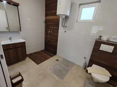 a bathroom with a toilet and a sink and a shower at Vinogradi Zmajevački in Mladenovac
