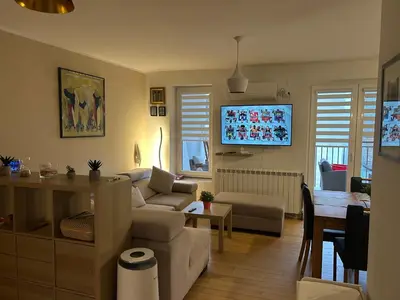 a living room with a couch and a table at Apartman Jevremov Kutak in Belgrade
