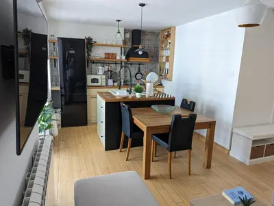 a kitchen and dining room with a table and chairs at Apartman Jevremov Kutak in Belgrade