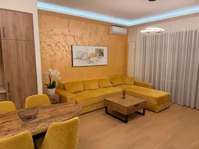 a living room with a couch and a table at Belgrade Waterfront KINGS Park Residences in Belgrade