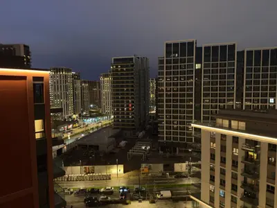 a view of a city at night with tall buildings at Belgrade Waterfront KINGS Park Residences in Belgrade