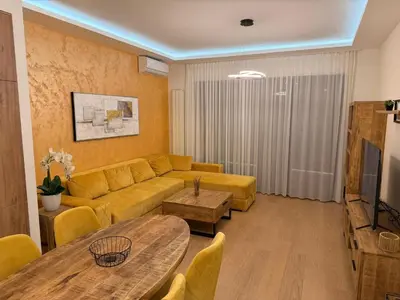 a living room with a couch and a table at Belgrade Waterfront KINGS Park Residences in Belgrade