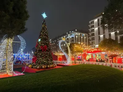 a christmas tree and lights in a city at night at Belgrade Waterfront KINGS Park Residences in Belgrade
